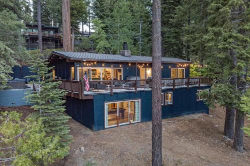 a blue house in the middle of the forest at Updated Cabin near Beach&Ski HotTub Sauna Pets EV in Tahoe City