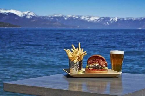a sandwich and french fries and a glass of beer at Updated Cabin near Beach&Ski HotTub Sauna Pets EV in Tahoe City