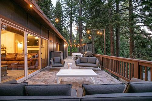 a patio with couches and a table on a deck at Updated Cabin near Beach&Ski HotTub Sauna Pets EV in Tahoe City