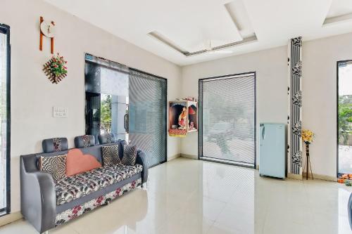 a living room with a blue couch in the middle at Hotel O Sai Kohinoor in Shirdi