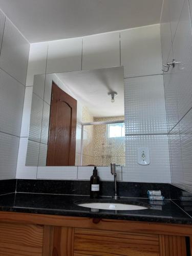 ein Badezimmer mit Waschbecken und Spiegel in der Unterkunft Atins Suites in Atins