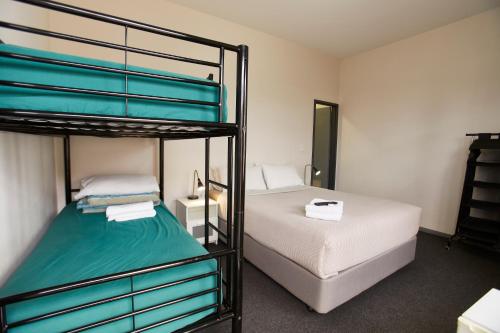 a bedroom with two bunk beds in a room at YHA Fremantle Prison in Fremantle