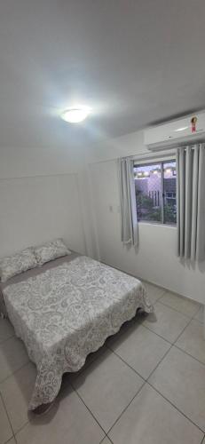 a bedroom with a bed and a window at Apartamento em Recife in Recife
