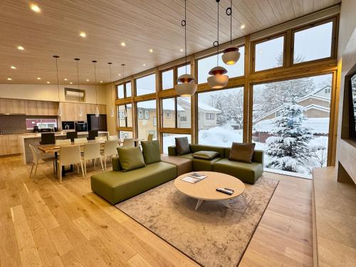 a living room with a couch and a table at KYLA by Hakuba White Fox, Echoland Luxe w Mountain Views in Hakuba
