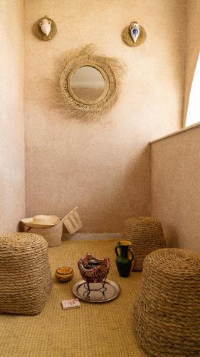a room with wicker chairs and a mirror on the wall at Private floor of a villa - 10 min to airport in Ariana