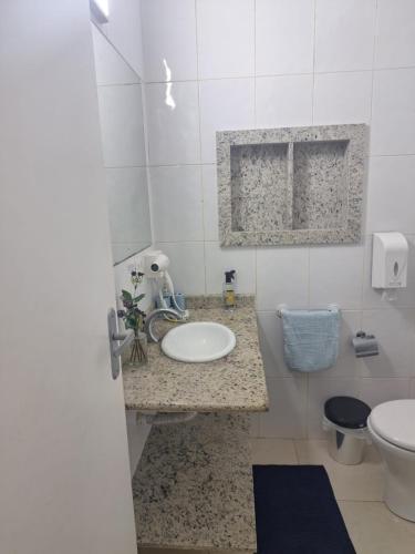 a bathroom with a sink and a toilet at Beach House 2 in Guarujá