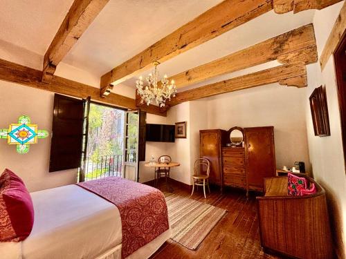 a bedroom with a large bed and a table at Molino de los Reyes in Totolac