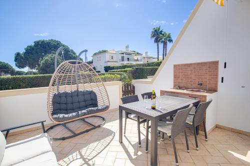 a patio with a table and chairs on a balcony at Nature Escape 2BR Villa Pool Wi-Fi AC in Olhos de Água