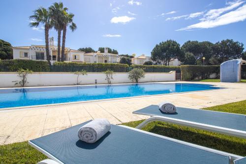 a swimming pool with two lounge chairs next to it at Nature Escape 2BR Villa Pool Wi-Fi AC in Olhos de Água