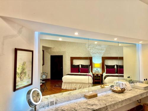 a bedroom with a bed and a large mirror at Molino de los Reyes in Totolac