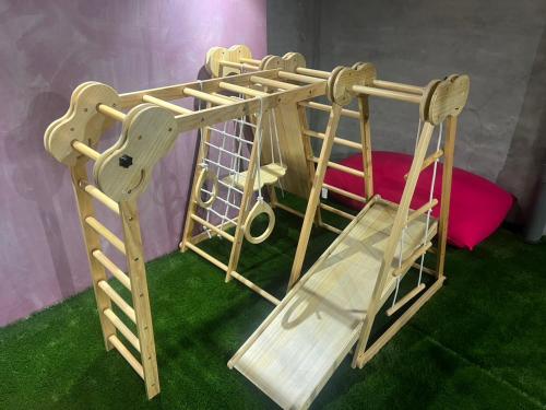 a wooden play set with a ladder and a slide at S9W13 LABOINN Large private house in Sapporo