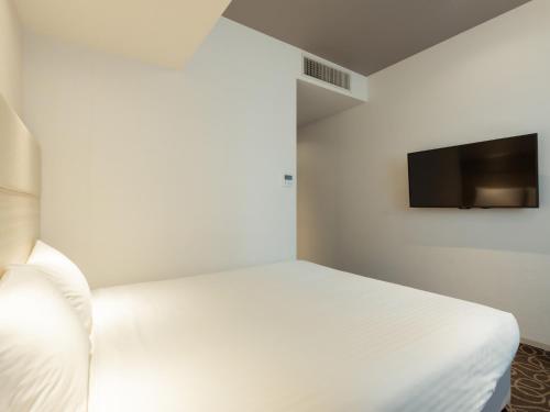 Katil atau katil-katil dalam bilik di Hotel Aqua Citta Naha