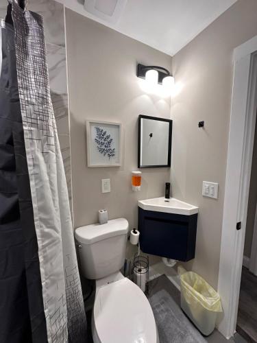 a bathroom with a toilet and a sink at Modern Comfort in Historic East Baltimore Stylish 3BR Row Home in Baltimore
