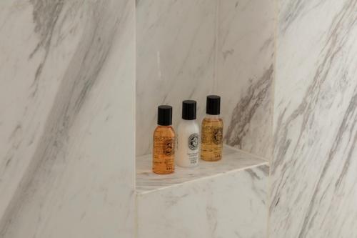 two bottles of shampoo sitting on a shelf in a bathroom at Skyline Cloud Cliff Sea View Hotel in Dali