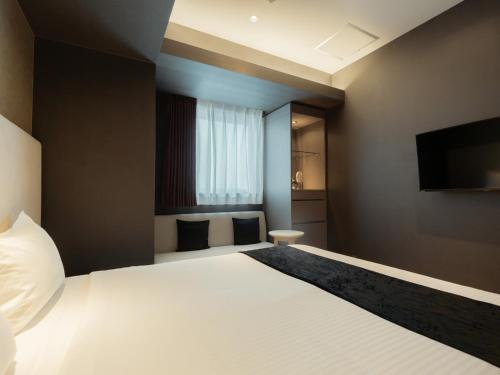 Katil atau katil-katil dalam bilik di Hotel Aqua Citta Naha