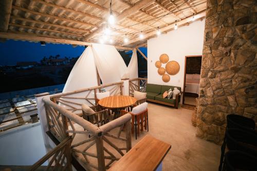 a room with a table and chairs and a bed at Saona Bangalôs Taíba in Taíba