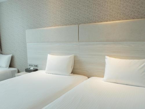 Katil atau katil-katil dalam bilik di Hotel Aqua Citta Naha