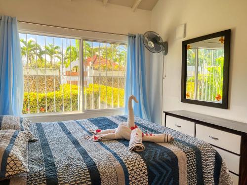 a bedroom with a bed with a toy on it at Mango house bliss in Las Galeras