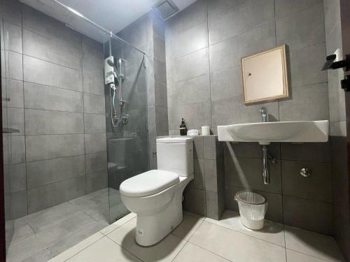 a bathroom with a toilet and a sink and a shower at Family Friendly Unit in K Avenue in Donggongon