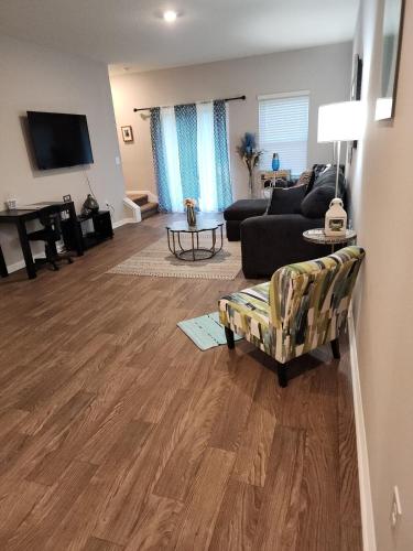 a living room with a couch and a table at Relaxing Modern 2BR Home - King Bd - Near DT JAX in Jacksonville
