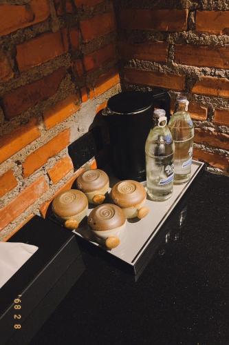 a tray with four donuts and two bottles of water at Santisookmidtown Pattani in Kampong Rusamileh
