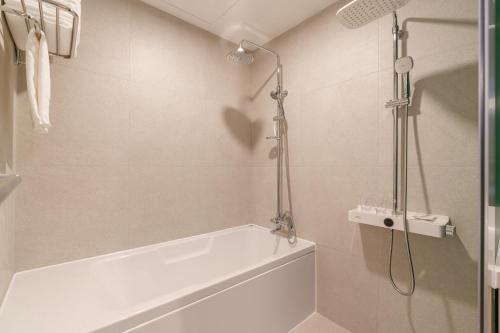 a bathroom with a shower and a bath tub at ibis Styles Ambassador Jeonju City Centre in Jeonju