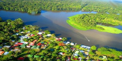 an aerial view of a lake with houses and trees at HOUSE Of Rainbow in Tortuguero