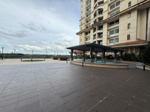 a pavilion in a parking lot in front of a building at Riverine Diamond Condominium at City Centre in Kuching
