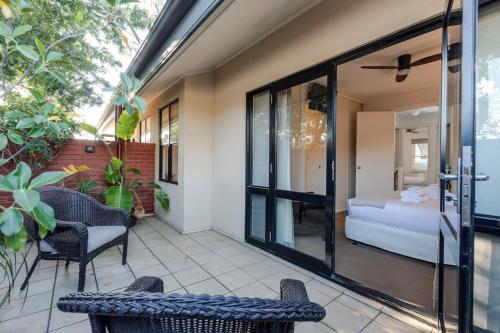 a room with a bed and a patio with chairs at The Terrace - close to Adelaide Oval Cafes CBD Shopping in North Adelaide