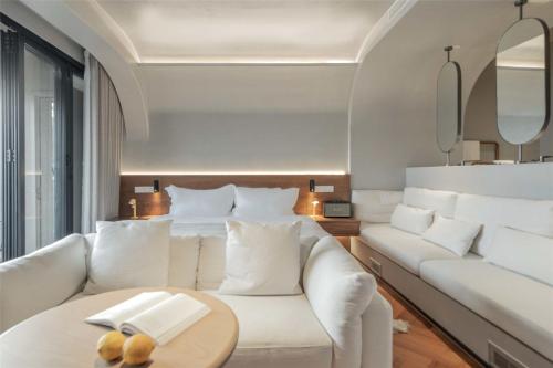 a living room with a white couch and a table at Skyline Cloud Cliff Sea View Hotel in Dali