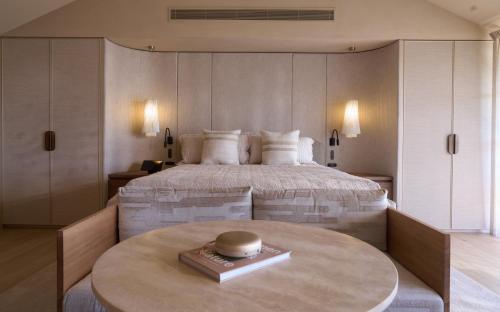 a bedroom with a large bed and a table at The Sanctuary at Alba Thermal Springs & Spa in Fingal
