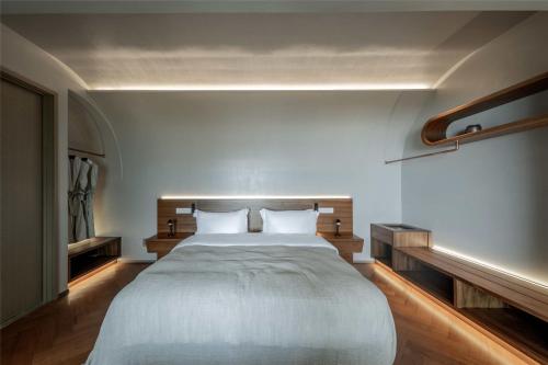 a bedroom with a large bed with two pillows at Skyline Cloud Cliff Sea View Hotel in Dali