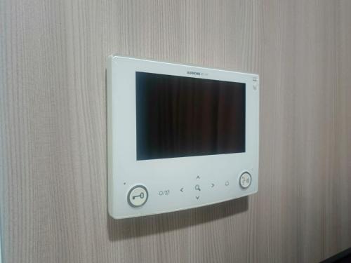 a white wii monitor hanging on a wall at Residencia Nova, Jakarta in Jakarta