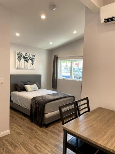 a bedroom with a bed and a dining room table at Modern 1-bedroom Studio with Kitchen and Laundry in Santa Clarita