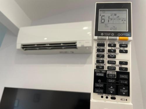 a remote control in front of a tv at Modern 1-bedroom Studio with Kitchen and Laundry in Santa Clarita