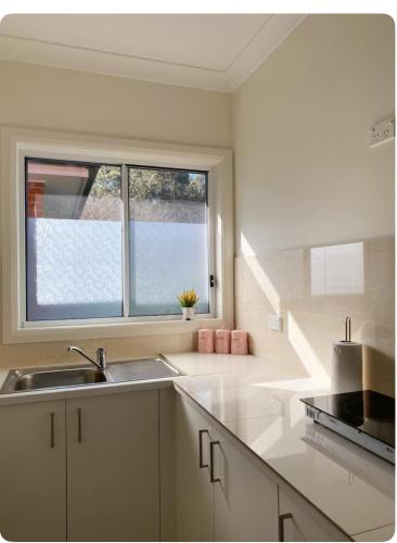 a kitchen with a sink and a window at Entire Studio Guesthouse in East Lindfield in Roseville