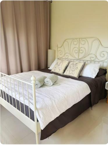 a white bed with pillows on it in a bedroom at Entire Studio Guesthouse in East Lindfield in Roseville