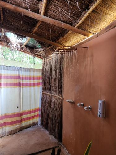 an empty room with a shower in a building at Ku kuk Glamping in Chemuyil