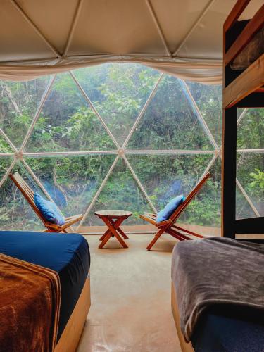 a room with two beds and a large window at Ku kuk Glamping in Chemuyil