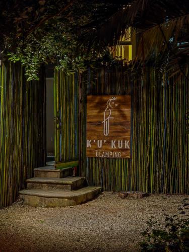 a sign on a building with stairs in front at Ku kuk Glamping in Chemuyil