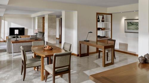 a living room with a table and chairs at Grand Hyatt Bali in Nusa Dua