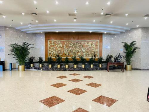 a lobby with potted plants and a large wall at The North Garden Hotel Beijing Wangfujing-Located in the city center,adjacent to Wangfujing Street,Tiananmen Square,the Forbidden City, offering Beijing tour service in Beijing
