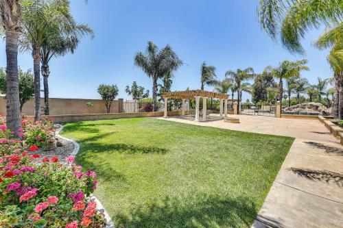 a garden with a gazebo and palm trees at Upscale Triplex with Pool Access in Riverside! in Riverside