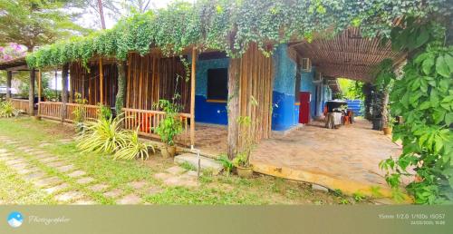 a house with a pergola with plants on it at Tanjung Inn in Kuantan