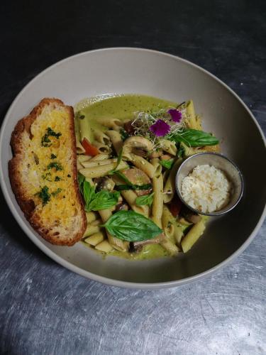 a plate of food with a bowl of soup and bread at Hotel El Congo in Drake