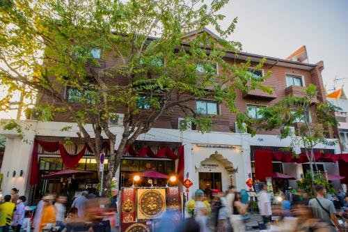 a crowd of people walking in front of a building at The Experience Walking Street Chiang Mai in Chiang Mai