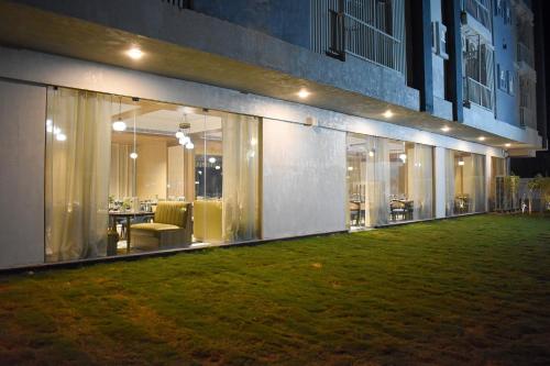 a building with a green lawn in front of it at Urban Suites by BluSalzz, Jaipur - Rajasthan in Jaipur