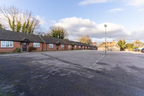 an empty parking lot in front of a brick building at Tyger Inn Derby in Derby
