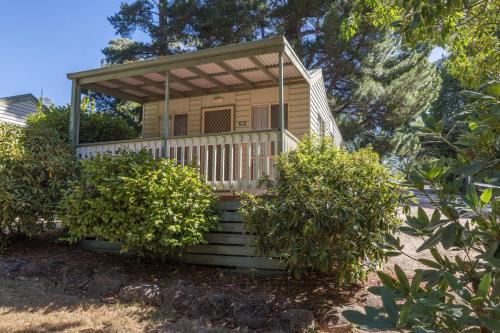 a house on the beach with trees and bushes at Daylesford Holiday Park in Daylesford