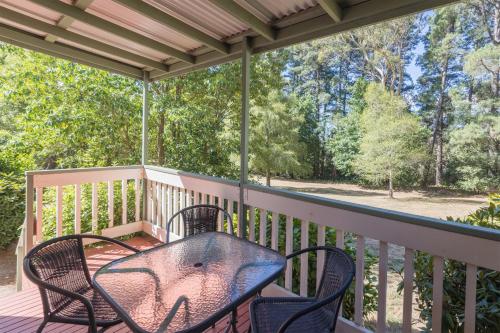 a patio with a table and chairs on a porch at Daylesford Holiday Park in Daylesford